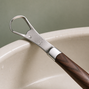Close-up of the polished stainless-steel loop and wood handle