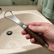 MSWK Tongue Cleaner held over a bathroom sink after rinsing